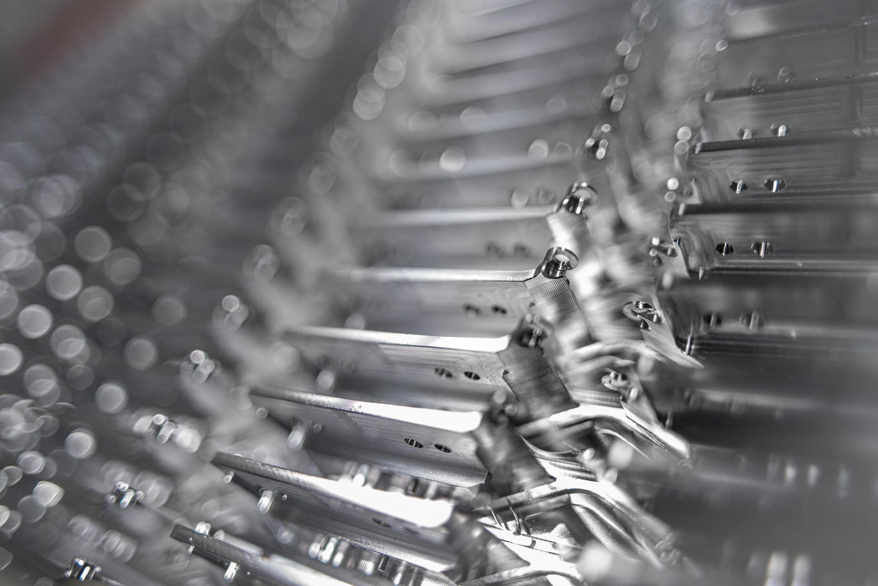 Close view of stacked machined parts in series