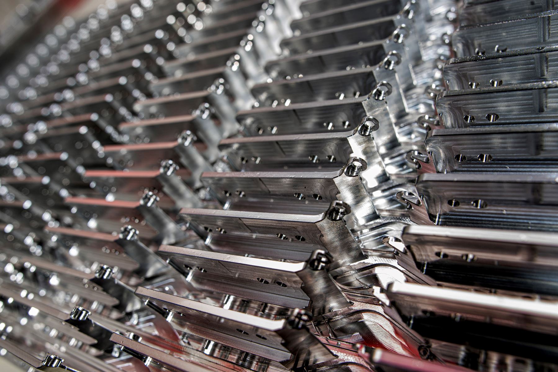 Stacked machined aluminum brackets from a production run