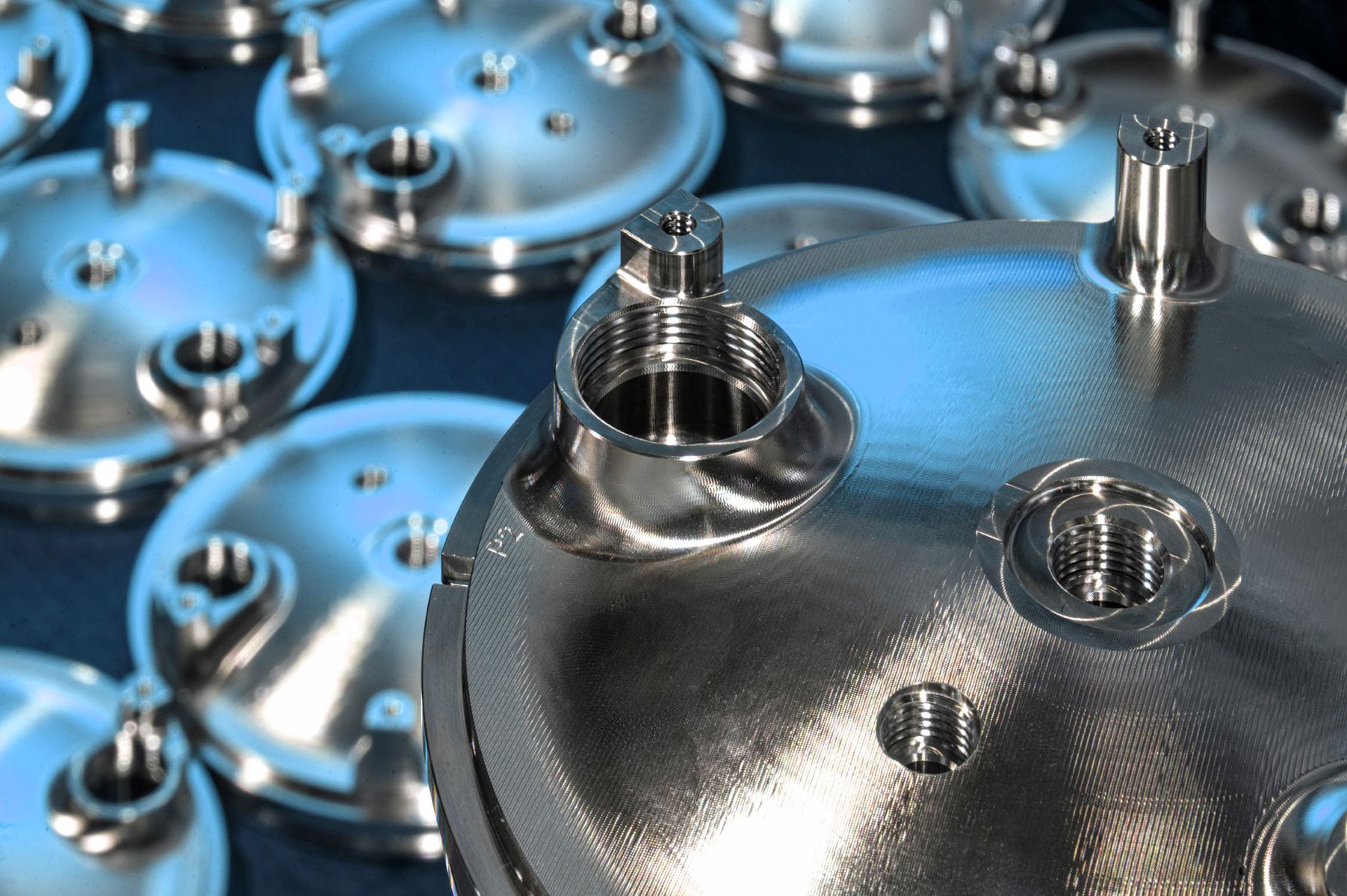 Machined metal domes with threaded bosses in batch