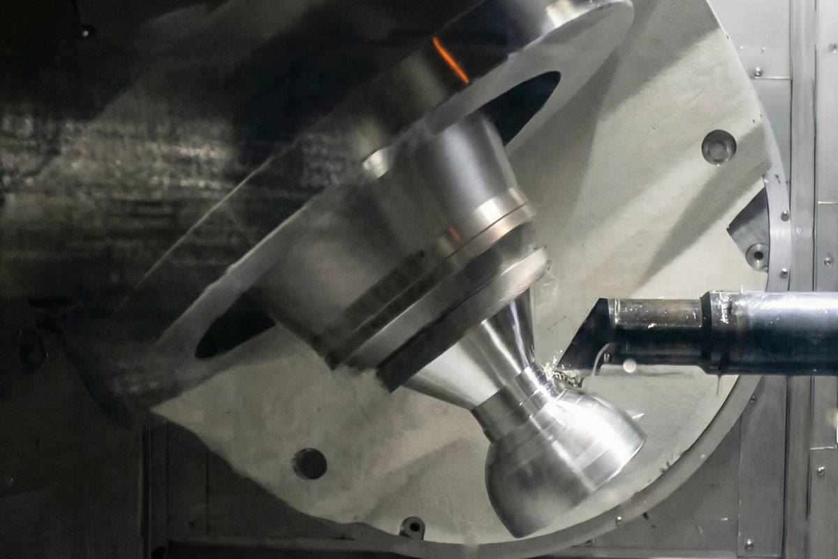Five axis turning of a nozzle shaped component