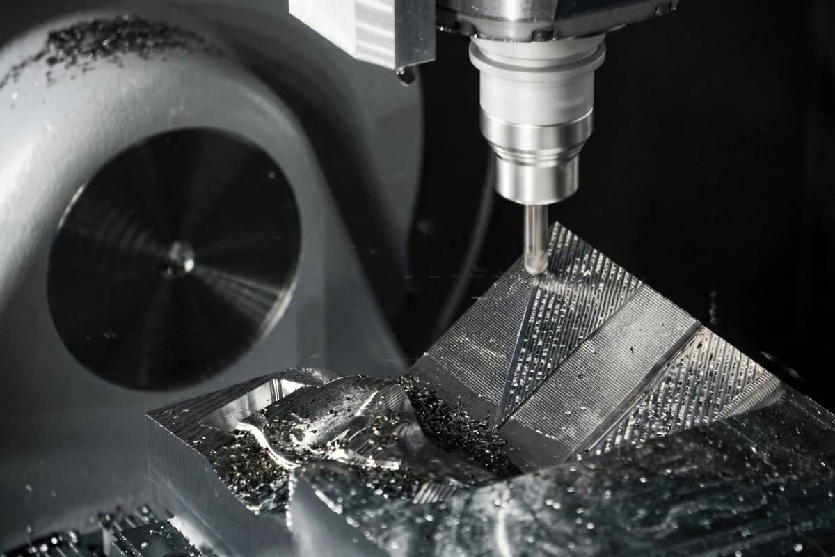 End mill cutting a steel block with chips