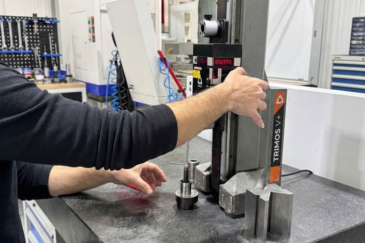 Operator measuring a subassembly with digital height gauge
