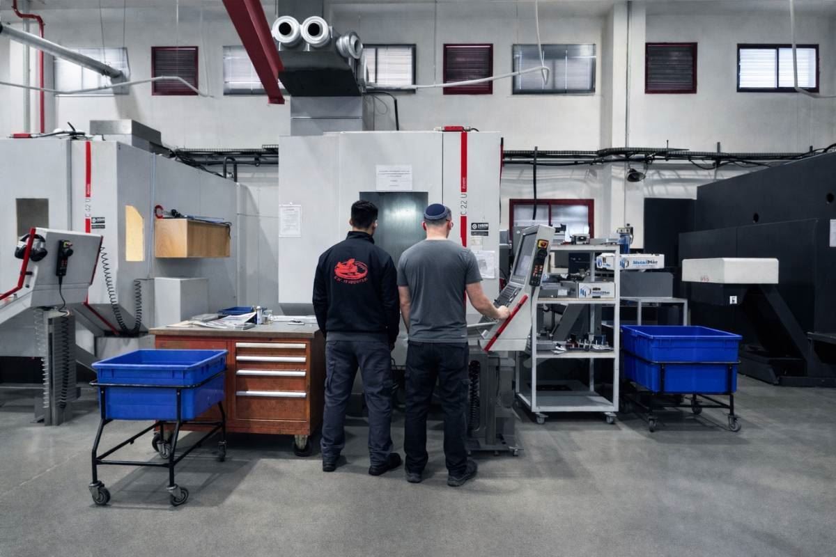 Two operators running a CNC machining centre together